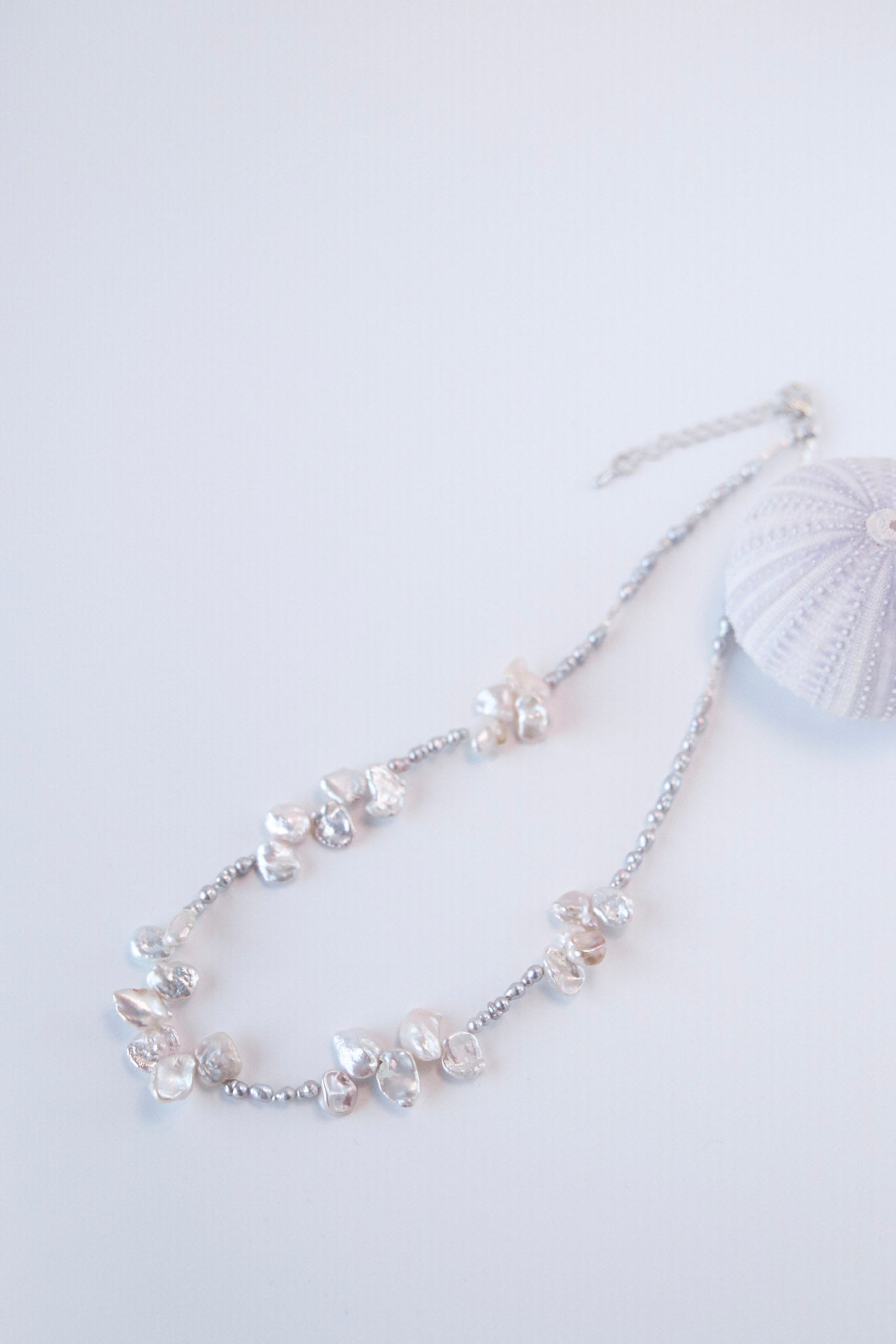 This exceptionally beautiful necklace is made of grey keshi pearls and white baroque pearls — like a blossom from the sea.