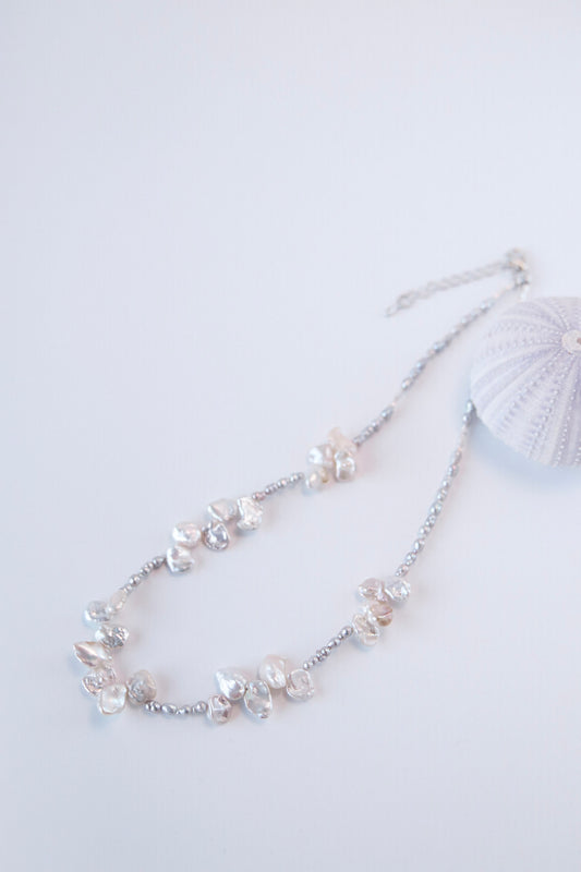 This exceptionally beautiful necklace is made of grey keshi pearls and white baroque pearls — like a blossom from the sea.