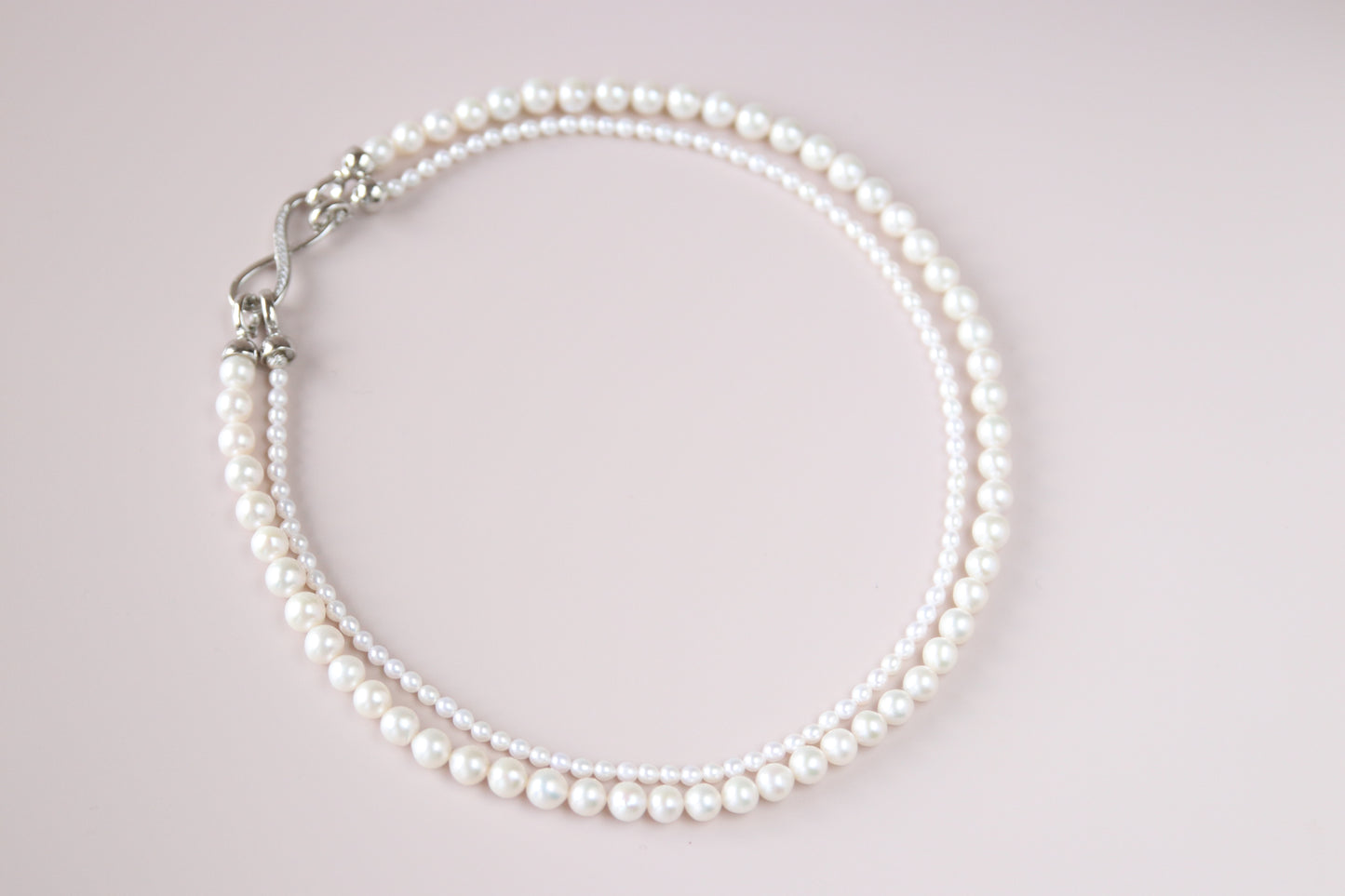 Thanks to its unique figure-8 clasp, both the fine and the bold pearl strands can be detached — giving you four elegant ways to wear it