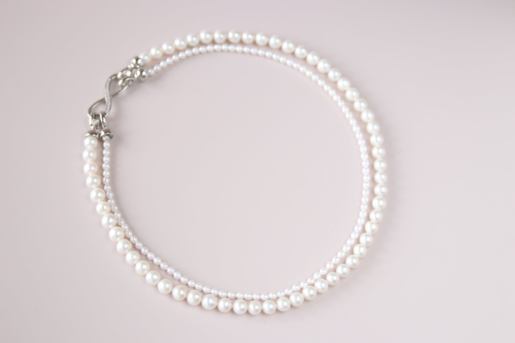 Thanks to its unique figure-8 clasp, both the fine and the bold pearl strands can be detached — giving you four elegant ways to wear it